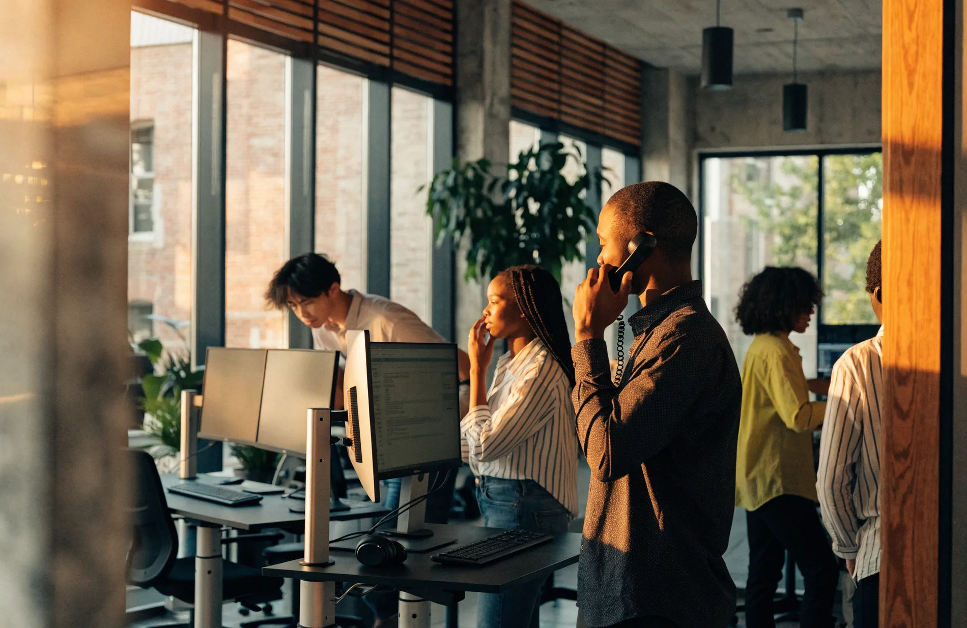 A team of freight brokers collaborating in a modern logistics office